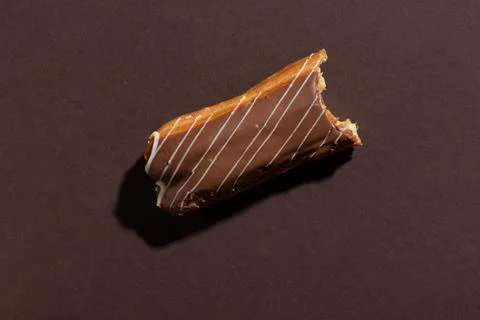 Chocolate eclair on a brown background Foto stock