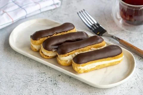 Chocolate eclair cake on gray background. Bakery products. close up Stock Photos