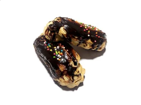 Chocolate eclair donuts on a white background Stock Photos