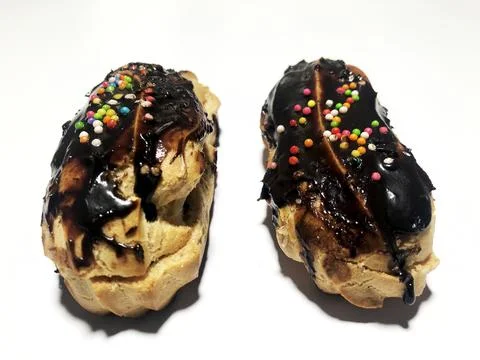 Chocolate eclair donuts on a white background Stock Photos