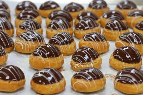 Chocolate eclair preparation, also known as chocolate profiteroles Stock Photos