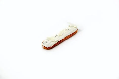 Chocolate eclair with white chocolate cream decor isolate on white background Stock Photos