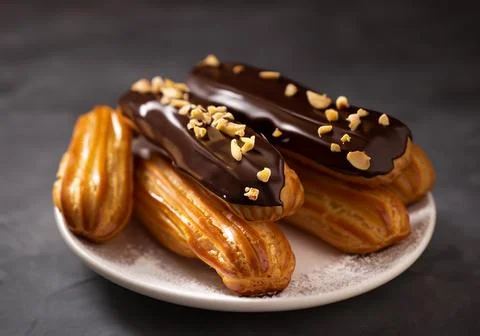 Chocolate eclairs with calamelized nuts Stock Photos