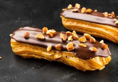 Chocolate eclairs with calamelized nuts Stock Photos