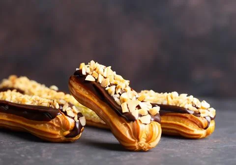 Chocolate eclairs with calamelized nuts Stock Photos