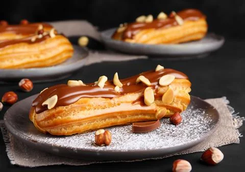 Chocolate eclairs with calamelized nuts Stock Photos