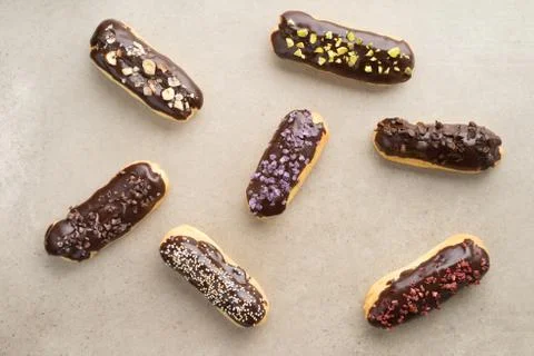 Chocolate eclairs with toppings Stock Photos