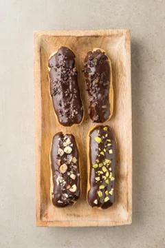 Chocolate eclairs with toppings Stock Photos
