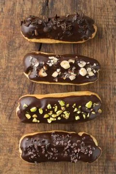 Chocolate eclairs with toppings Stock Photos