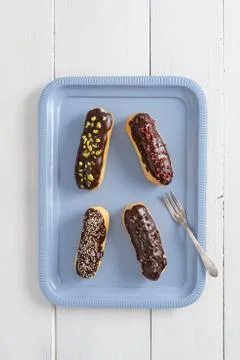Chocolate eclairs with toppings Foto stock