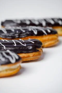 Chocolate eclairs on a white background ready to eat Stock Photos