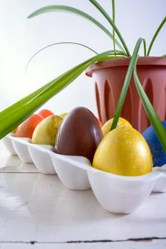 Chocolate egg among colored easter eggs. Stock Photos