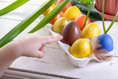 Chocolate egg among colored easter eggs Stock Photos