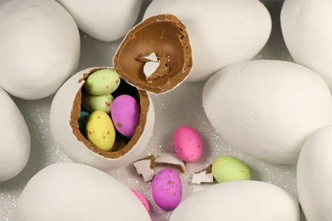 Chocolate Egg Filled With Colorful Speckled Candy Eggs Stock Photos