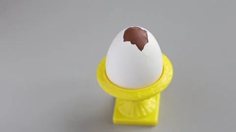Chocolate egg with real eggshell in a yellow cup. Easter tradition in Finland. Stock Footage 312164069