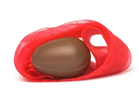 Chocolate egg in red bow Stock Photos
