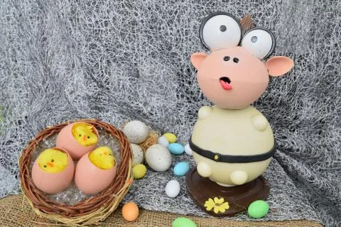 Chocolate egg in the shape of a lamb with various decorations Stock Photos