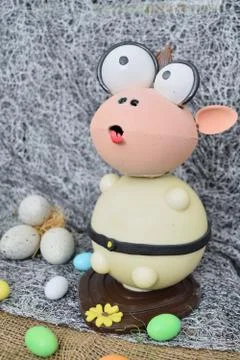 Chocolate egg in the shape of a lamb with various decorations Photos