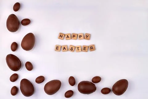 Chocolate eggs and happy easter congratulation. Stock Photos