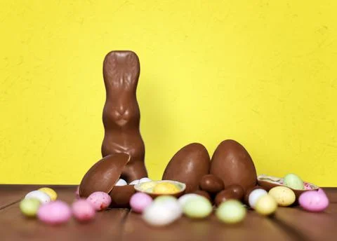 Chocolate eggs, easter bunny and candies on wood Stock Photos