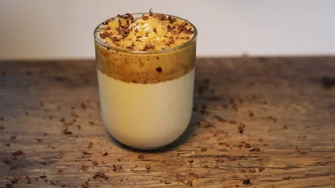Chocolate is falling down on Dalgona Coffee Stock Footage 130400271