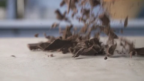 Chocolate falling onto a kitchen surface in slow motion Stock Footage 89935542