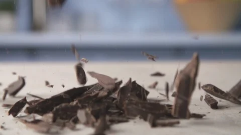 Chocolate falling onto a kitchen surface in slow motion Stock Footage 89935609