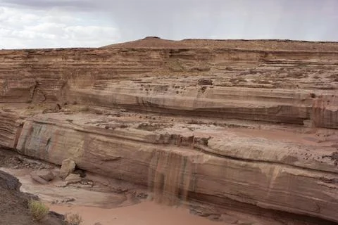 Chocolate Falls cascading down a red rock formation in a desert canyon land.. Stock Photos