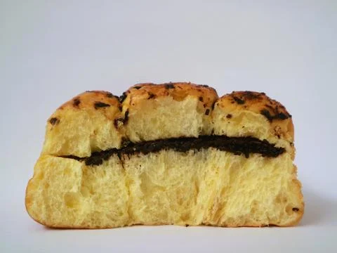 A chocolate-filled bread bun or pastry, isolated on white background Stock Photos