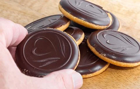 A chocolate-filled cookie in hand Stock Photos