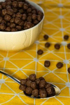 Chocolate flake balls, in a deep dish on a yellow bright tablecloth Stock Photos