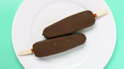 Chocolate flavor popsicle with the other of vanilla flavor melting timelapse 8K Stock Footage 135774853