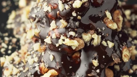 Chocolate flow down beautifully from a nutty dessert, slow motion. Stock Footage 144485464
