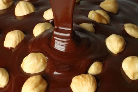 Chocolate flows with nuts Stock Photos