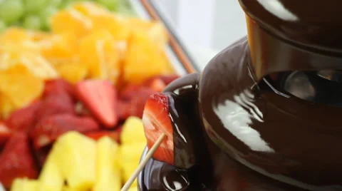 Chocolate fountain and fruit on skewer Stock Footage