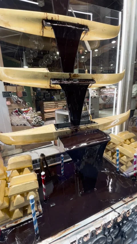 Chocolate fountain display case beautifully displayed in a store Stock Footage 302193353