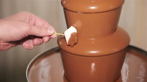 Chocolate fountain placed on a table Stock Footage 62486750