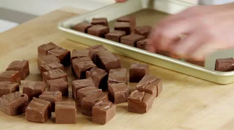 Chocolate fudge being placed on baking tray Stock Footage 24672776