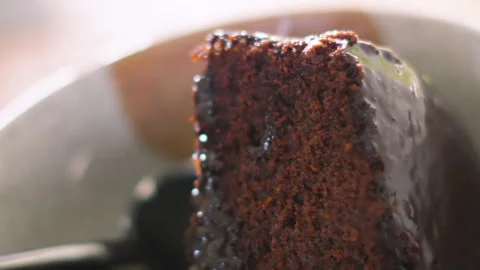 Chocolate Fudge Cake with Soft Sponge and Shiny Glaze in Bowl with Spoon. Stock Footage 333547641