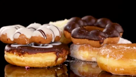 Chocolate Glazed Donut Ring Dropping Onto Assorted Pastries Stock Footage 315028062