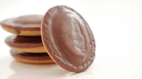 Chocolate glazed orange biscuits on white background  slow panning 4K 2160p U Stock Footage 55550384