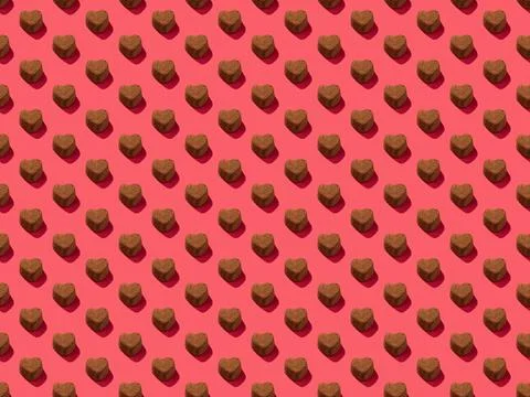 Chocolate heart candy on a pink background pattern 写真素材