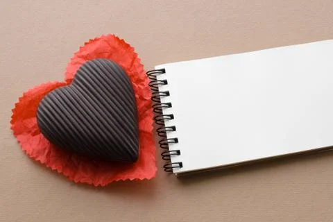 Chocolate heart, empty notebook, copy space Foto stock