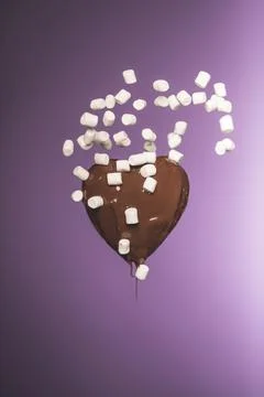 Chocolate heart shaped candy falling Stock-Fotos