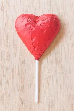 Chocolate hearts candies on wooden background Stock-Fotos