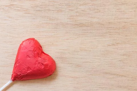 Chocolate hearts candies on wooden background Stock Photos