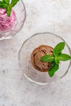 Chocolate ice cream with mint leaf in a transparent bowl Stock Photos