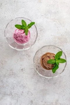 Chocolate ice cream with mint leaf in a transparent bowl Stock-Fotos