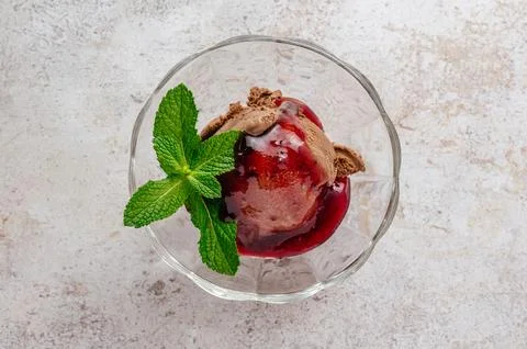 Chocolate ice cream with mint leaf in a transparent bowl Stock-Fotos