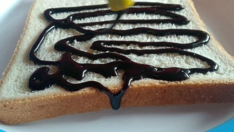 Chocolate icing on bread. Stock Footage 154534112